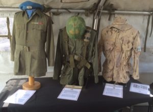 L-R Bush Jacket, 1963 Pattern Combat Shirt, Webbing and Helmet; CADPAT jacket and Boonie Hat 